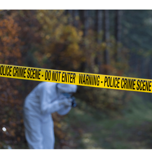 Crime Scene with a person in a hazmat suite taking a picture