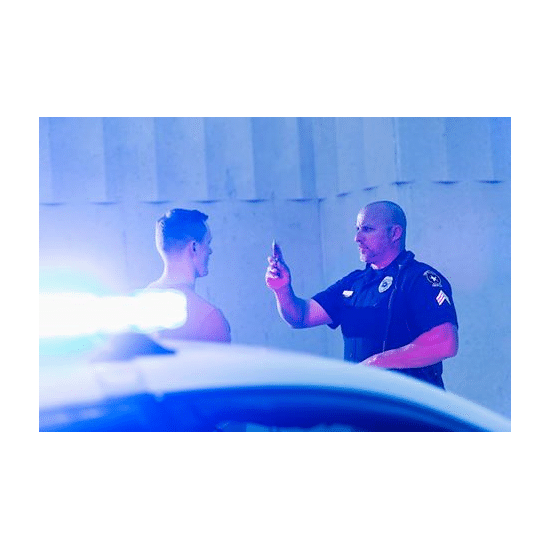 Police officer giving a young man a sobriety test